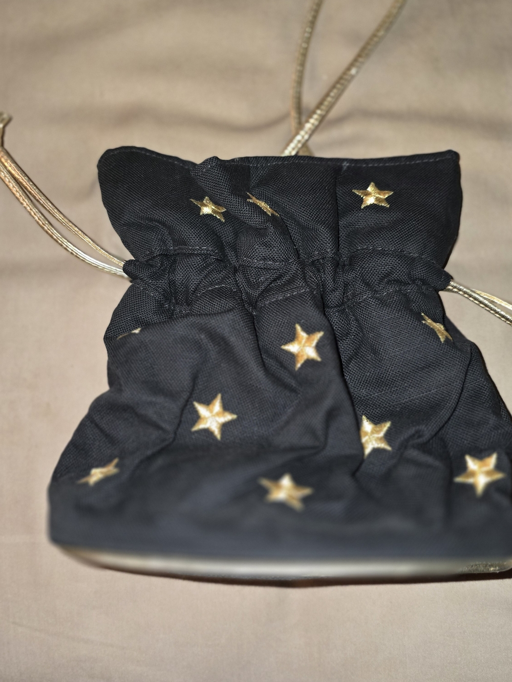 Icing Black Drawstring Crossbody Bag with Gold Star Accents